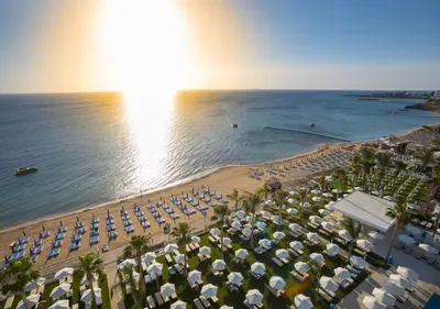 an aerial view of a beach with umbrellas and the ocean at Constantinos the Great Beach Hotel in Protaras
