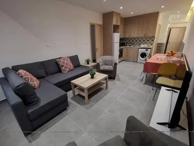 a living room with a couch and a table at Martins 3 Bedroom Flat in Larnaka