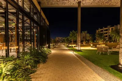 a walkway in front of a building at night at Rooftop Sunset Garden by Staycom in Pamboula
