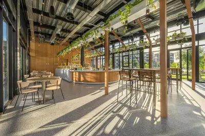 a restaurant with tables and chairs and a bar at Rooftop Sunset Garden by Staycom in Pamboula