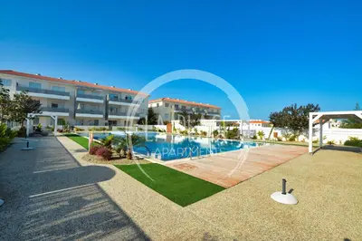a swimming pool in front of a building at Cosy 2Br Family Apartment - Mythical Sands Resort in Paralimni