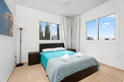 a bedroom with a bed with two towels on it at Cosy 2Br Family Apartment - Mythical Sands Resort in Paralimni