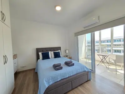 a bedroom with a bed with two towels on it at 1 bd at Mediterranean Beach - Limassol Bay B206 in Limassol