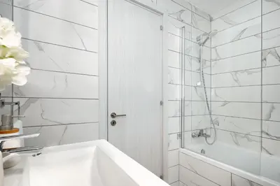 a white bathroom with a tub and a shower at Villa Brigita in Ayia Napa