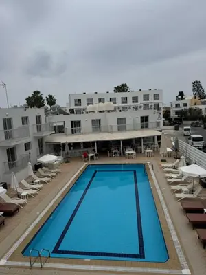 a large swimming pool in front of a building at Mangoes & Cherries in Ayia Napa