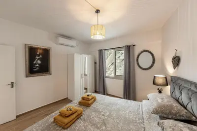 a bedroom with a large bed with two towels on it at Galata Watermill Cottage in Nicosia
