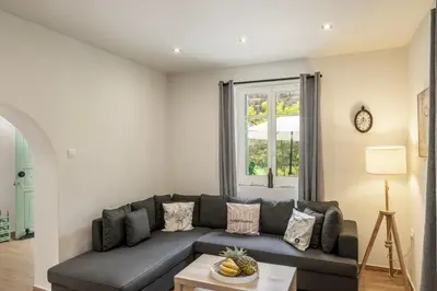 a living room with a couch and a window at Galata Watermill Cottage in Nicosia