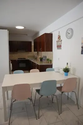 a kitchen with a large white table and chairs at Martin 2 bed Apartment in Larnaka