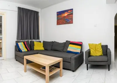 a living room with a couch and a chair at Martin 2 bed Apartment in Larnaka