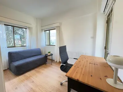 a living room with a couch and a table at Stasandrou City Center Residence in Nicosia