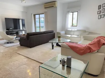 a living room with a couch and a table at Stasandrou City Center Residence in Nicosia