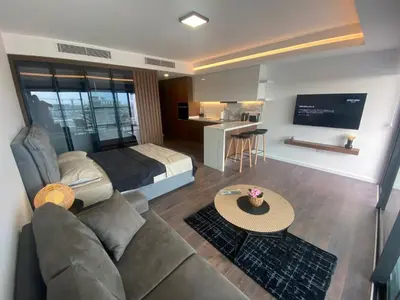 a living room with a couch and a bed at Grand Sapphire Resort & Casino in Phikardhou