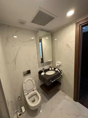 a bathroom with a toilet and a sink in it at Grand Sapphire Resort & Casino in Phikardhou