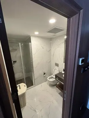 a bathroom with a toilet and a shower and a sink at Grand Sapphire Resort & Casino in Phikardhou