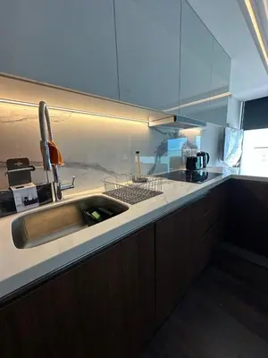 a kitchen with a sink and a counter top at Grand Sapphire Resort & Casino in Phikardhou