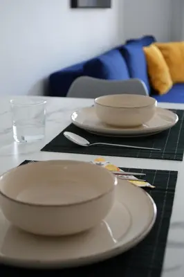 a table with two plates and a glass of water at Nomad's Nest - Quiet flat with terrace in Ayia Napa