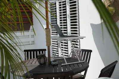 a wooden table with two chairs on a patio at Nomad's Nest - Quiet flat with terrace in Ayia Napa