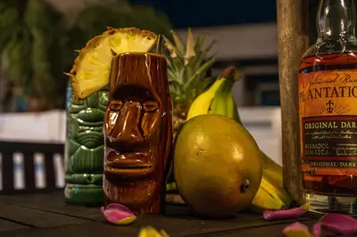 a table topped with fruit and a bottle of alcohol at Nomad's Nest - Quiet flat with terrace in Ayia Napa