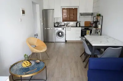 a kitchen with a table with a bowl of bananas on it at Nomad's Nest - Quiet flat with terrace in Ayia Napa