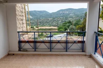 a balcony with a view of a road and mountains at Villa Althea, Pool, Mountain Views, BBQ ,Patio in Laneia in Lania