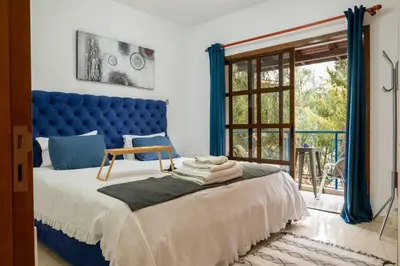 a bed with a blue headboard in a room at Villa Althea, Pool, Mountain Views, BBQ ,Patio in Laneia in Lania