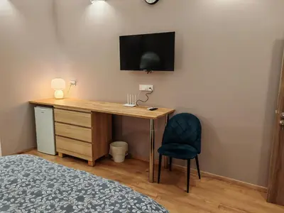 a bedroom with a desk with a tv and a chair at Studio in the center of Nicosia 3 in Nicosia