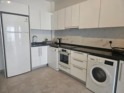 a kitchen with a white refrigerator and a dishwasher at Seaview Apartment at Caesar Blue Complex Northern Cyprus H68 in Dherinia