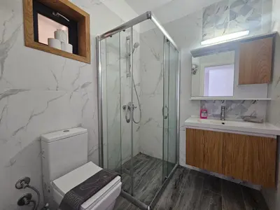 a bathroom with a shower and a toilet and a sink at Seaview Apartment at Caesar Blue Complex Northern Cyprus H68 in Dherinia