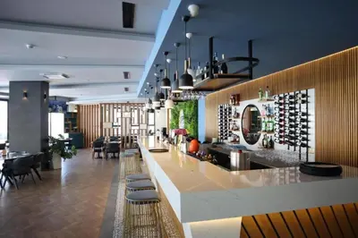 a bar in a room with wine bottles on the wall at Seaview Apartment at Caesar Blue Complex Northern Cyprus H68 in Dherinia