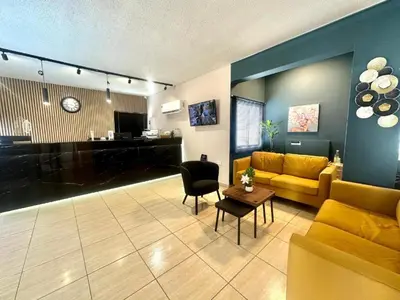 a living room with a couch and a table at NÓA Rooms - Adults Only in Ayia Napa