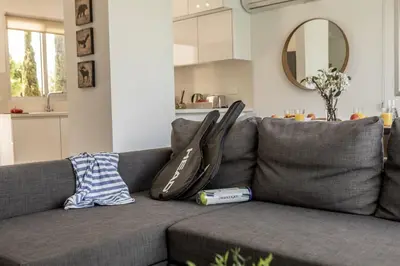 a gray couch with two pillows on top of it at Sam's Villa in Paralimni
