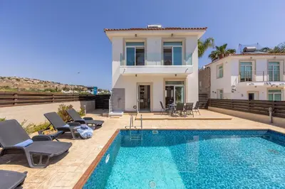 a villa with a swimming pool and a house at Villa Parrog in Protaras