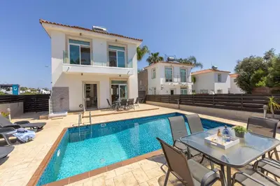a villa with a swimming pool and a house at Villa Parrog in Protaras