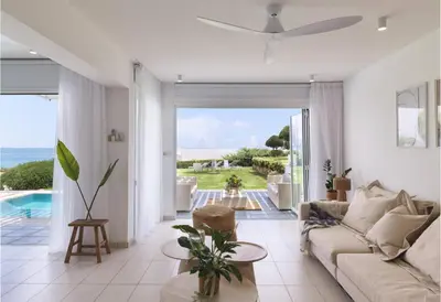 a living room with a couch and a view of the ocean at Sirena Solis Villa - Elegant 5-bedroom Sea View Retreat near Sirena Bay in Protaras