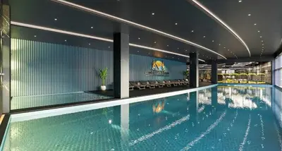 a large swimming pool in a building at Grand Sapphire Resort in Aglantzia