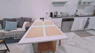 a white table in a living room with a couch at STAY The Getaway Apartment in Pyla