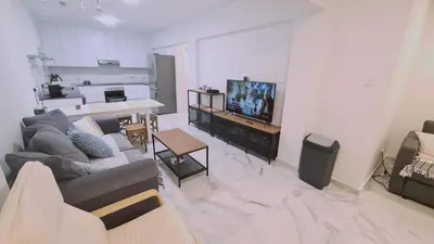 a living room with a couch and a tv at STAY The Getaway Apartment in Pyla