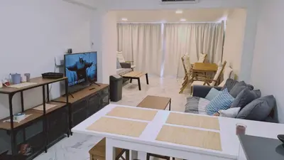 a living room with a couch and a tv at STAY The Getaway Apartment in Pyla