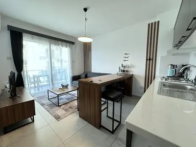 a kitchen and living room with a table and a couch at Cheap Holiday Opportunity in North Cyprus in Larnaka