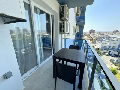 a balcony with a table and chairs on a balcony at Cheap Holiday Opportunity in North Cyprus in Larnaka