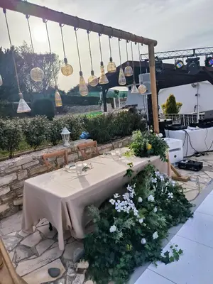 a table with flowers and lights on a patio at Ambelli Villa 4 Bedroom Luxury Villa in Skarinou