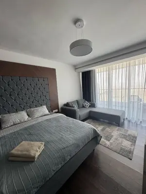 a bedroom with a bed and a couch at Grand Saphire Resort Apartment-I in İskele