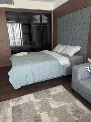 a bedroom with a large bed and a couch at Grand Saphire Resort Apartment-I in İskele