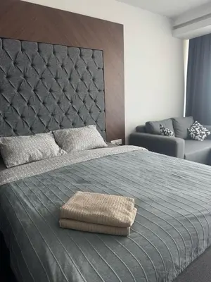 a bedroom with a large bed with a large headboard at Grand Saphire Resort Apartment-I in İskele
