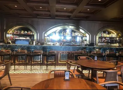a restaurant with tables and chairs and a bar at Grand Sapphire Resort in Aglantzia