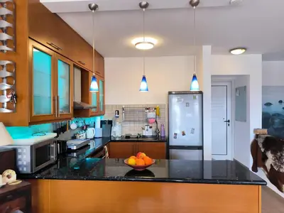 a kitchen with a bowl of oranges on a counter at 2 Bed Apartment Pool and Sea Views in Oroklini in Voroklini