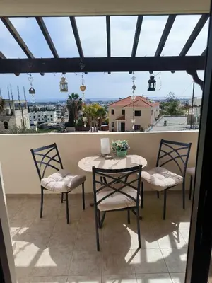a table and chairs on a balcony with a view at 2 Bed Apartment Pool and Sea Views in Oroklini in Voroklini