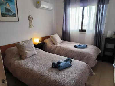 two beds in a room with two stuffed animals on them at 2 Bed Apartment Pool and Sea Views in Oroklini in Voroklini
