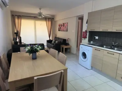 a kitchen and living room with a table and a dining room at 2 Bed Apartment in Kiti with Communal Pool in Kiti