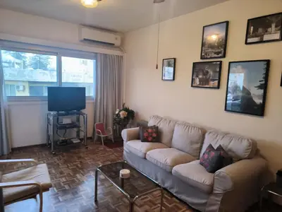 a living room with a couch and a tv at 3 Bedroom Apartment Old Town Larnaca 5 minute walk to Finnikoudes Beach in Larnaka